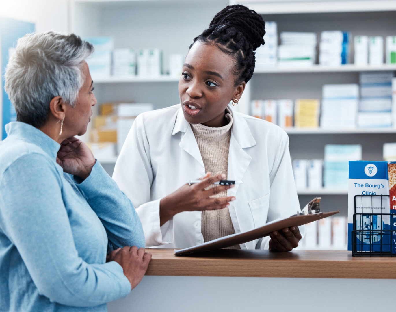 A woman talking to a pharmacist in front of her.